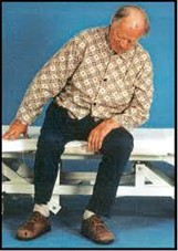 Man with Pusher Syndrome sat on plinth